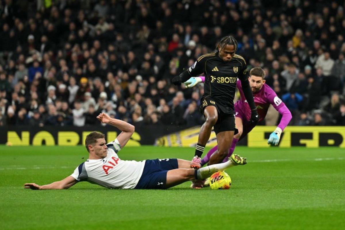 Tottenham Hotspur's Dutch defender #37 Micky van de Ven (L) tackles Fulham's Nigerian midfielder #19 Samuel Chukwueze during the English Premier League football match between Tottenham Hotspur and Fulham at the Tottenham Hotspur Stadium in London, on November 29, 2025.  Glyn KIRK / AFP