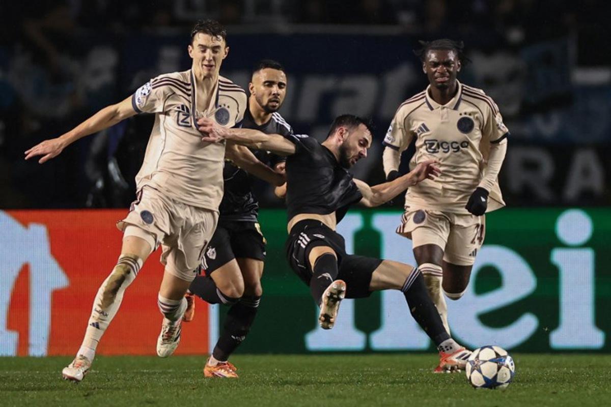 Ajax's Dutch defender #15 Youri Baas and Qarabag's Montenegrin midfielder #08 Marko Jankovic vie for the ball during the UEFA Champions League league phase football match between Qarabag and Ajax at the Tofiq Bahramov Republican Stadium in Baku on December 10, 2025.  Giorgi ARJEVANIDZE / AFP