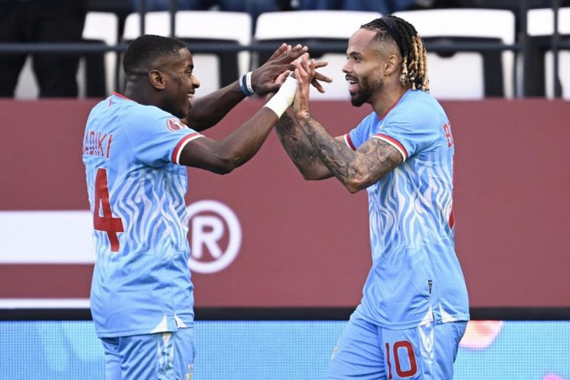 Democratic Republic Of Congo's forward #10 Theo Bongonda celebrates his goal with Democratic Republic Of Congo's midfielder #14 Noah Sadiki during the Africa Cup of Nations (CAN) Group D football match between Democratic Republic of Congo and Benin at Al Medina Stadium in Rabat on December 23, 2025.   SEBASTIEN BOZON / AFP