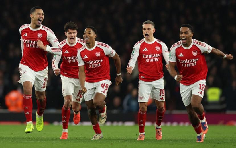 Arsenal's French defender #02 William Saliba (L), Arsenal's Danish defender #16 Christian Norgaard, Arsenal's English midfielder #49 Myles Lewis-Skelly, Arsenal's Belgian midfielder #19 Leandro Trossard and Arsenal's Dutch defender #12 Jurrien Timber celebrate at winning the English League Cup quarter-final football match between Arsenal and Crystal Palace at the Emirates Stadium, in London on December 23, 2025.  Adrian Dennis / AFP