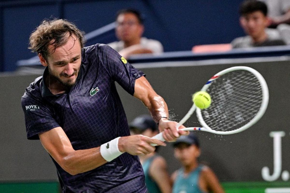 Russia's Daniil Medvedev hits a return to France's Arthur Rinderknech during their men's singles semi-final match at the Shanghai Masters tennis tournament in Shanghai on October 11, 2025.  Hector RETAMAL / AFP