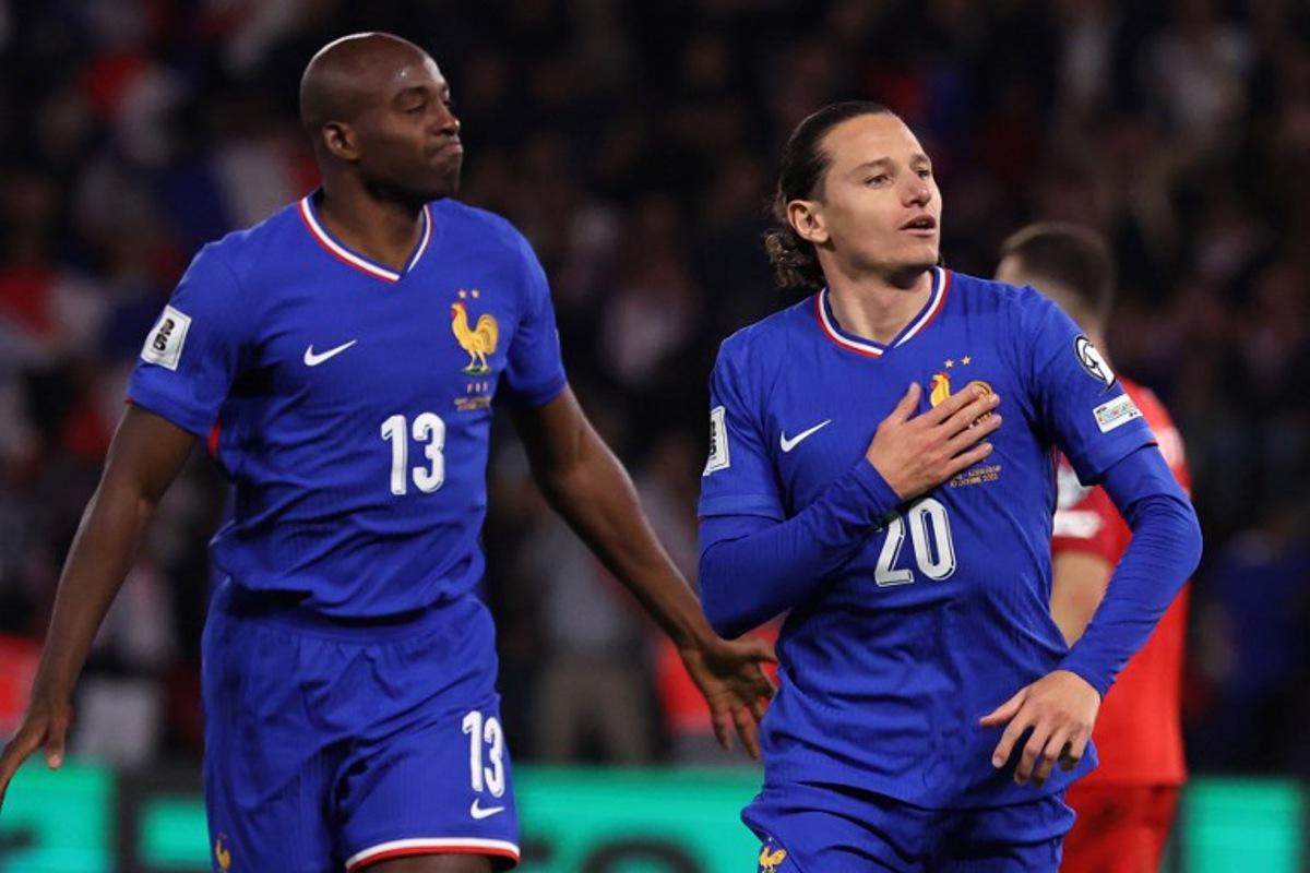 France's forward #20 Florian Thauvin (R) celebrates after scoring France's third goal during the FIFA World Cup 2026 Group D European qualification football match between France and Azerbaidjan at the Parc des Princes Stadium in Paris, on October 10, 2025.  Anne-Christine POUJOULAT / AFP
