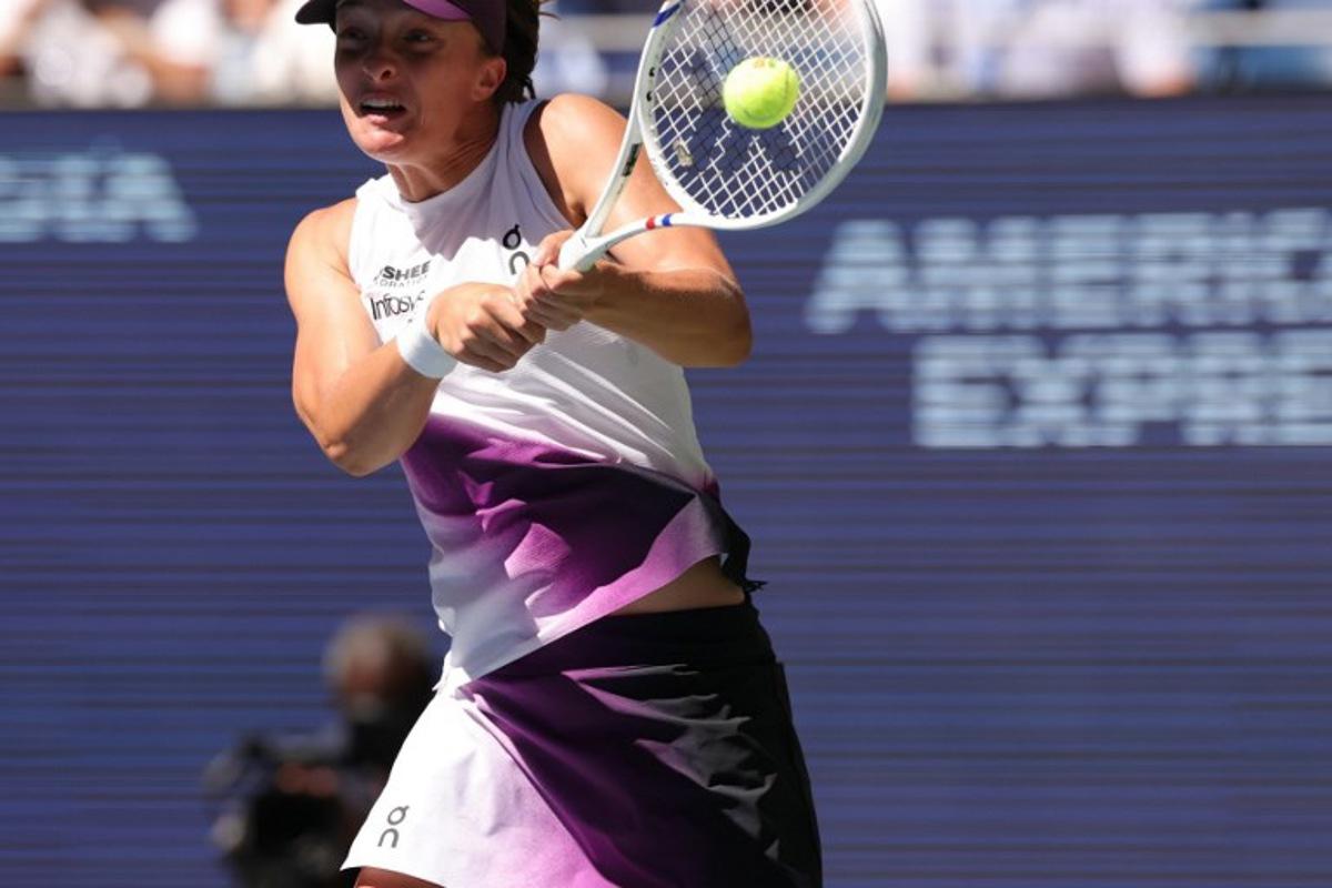 Poland's Iga Swiatek hits a return against China's Qinwen Zheng during their women's singles round of 16 tennis match on day nine of the US Open tennis tournament at the USTA Billie Jean King National Tennis Center in New York City on September 7, 2026.  KENA BETANCUR / AFP