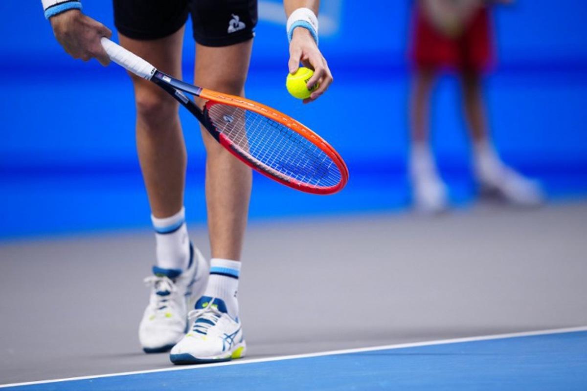 A tennis players holds racquet and ball to play a serve to his opponent during a match of the Erste Bank Open tennis tournament in Vienna on October 26, 2023.  Eva MANHART / APA / AFP