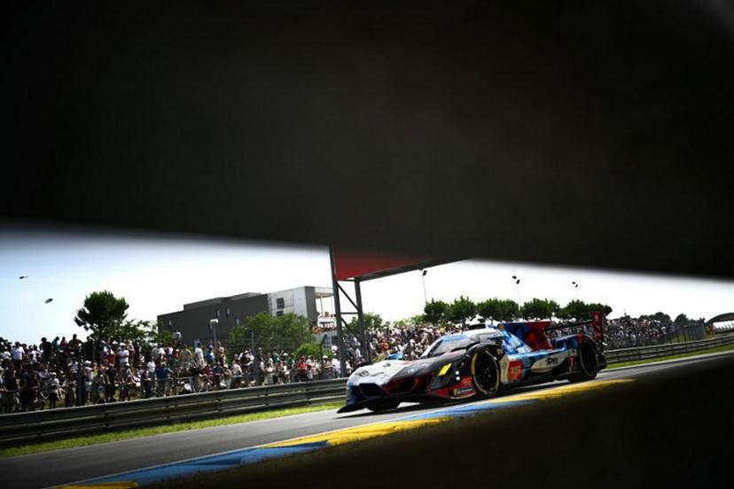 This photograph shows BMW M Team WRT's hypercar driven by Danish Kevin Magnussen, Italian Raffaele Marciello and Belgian Dries Vanthoor during the 94th edition of the 24 Hours of Le Mans at the Le Mans circuit, north-western France on June 13, 2026.  Lou BENOIST / AFP