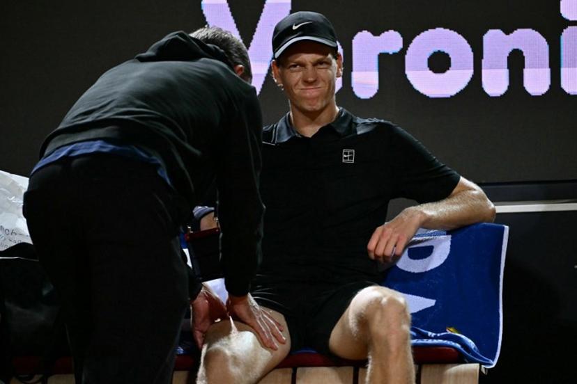 Italy's Jannik Sinner grimaces as he receives a massage during a break in the semi-final match against  Russia's Daniil Medvedev at the ATP Rome Open tennis tournament at Foro Italico in Rome on May 15, 2026.   Filippo MONTEFORTE / AFP