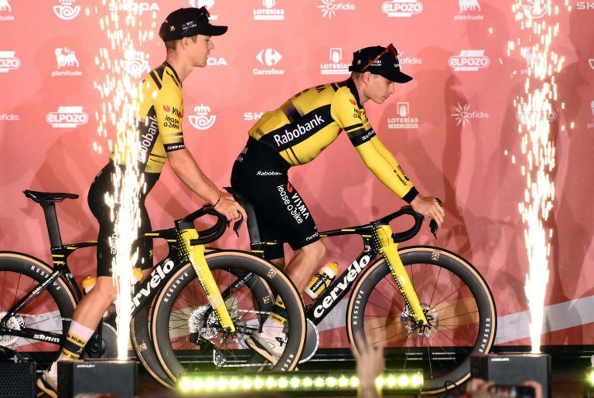 Team Visma-Lease a bike's Danish rider Jonas Vingegaard (R) rides his bike on stage during the official teams presentation of the 80th edition of 'La Vuelta' cycling tour of Spain, in Torino, Italy on August 21, 2025.  Marco BERTORELLO / AFP