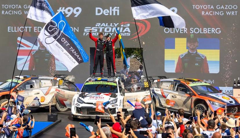 Winners Swedish Oliver Solberg (R) and his British co-driver Elliott Edmondson celebrate on the podium after winning the Rally Estonia, the eighth round of the FIA World Rally Championship, on July 20, 2025 in Kaariku, Estonia.  TIMO ANIS / AFP