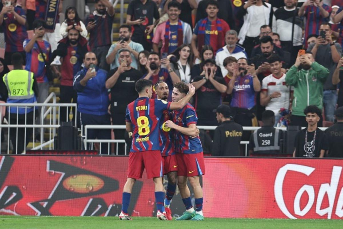 Barcelona's Spanish midfielder #16 Fermin Lopez (R) celebrates with teammates after scoring his team's second goal during the Spanish Supercup semi-final football match between FC Barcelona and Athletic Bilbao at King Abdullah Sports City in Jeddah on January 7, 2026.  Fadel SENNA / AFP