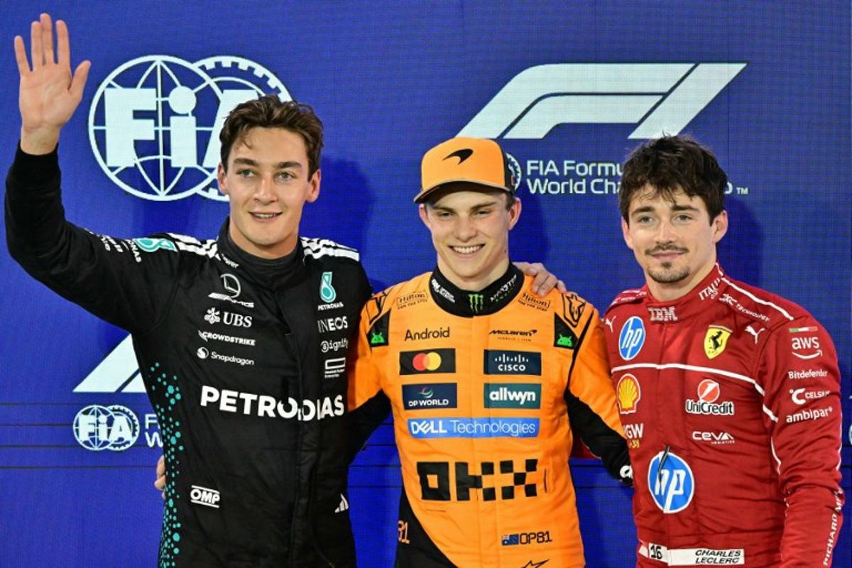 Mercedes' British driver George Russell, McLaren's Australian driver Oscar Piastri and Ferrari's Monegasque driver Charles Leclerc pose after the qualifying session ahead of the Bahrain Formula One Grand Prix at the Bahrain International Circuit in Sakhir on April 12, 2025.  Giuseppe CACACE / AFP