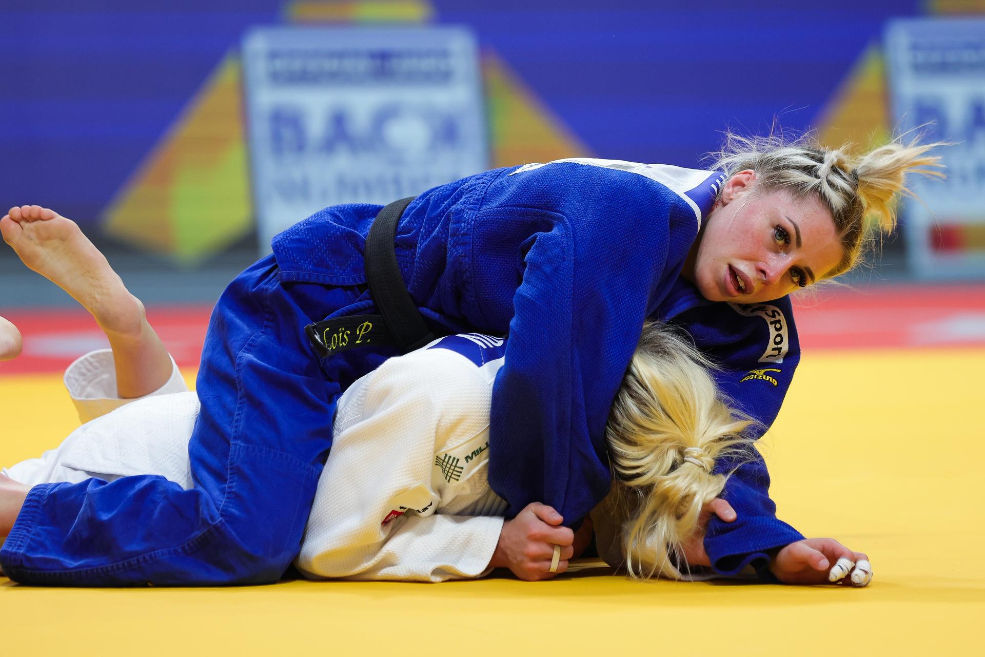 Belgian Lois Petit (blue gi) and Serbian Andrea Stojadinov (white gi) pictured in action during their bout in the Women's -48kg category, at the European Championships judo in Podgorica, Montenegro, on Wednesday 23 April 2025. The tournament is taking place from 23 tot 27 April 2025. BELGA PHOTO NIKOLA KRISTC