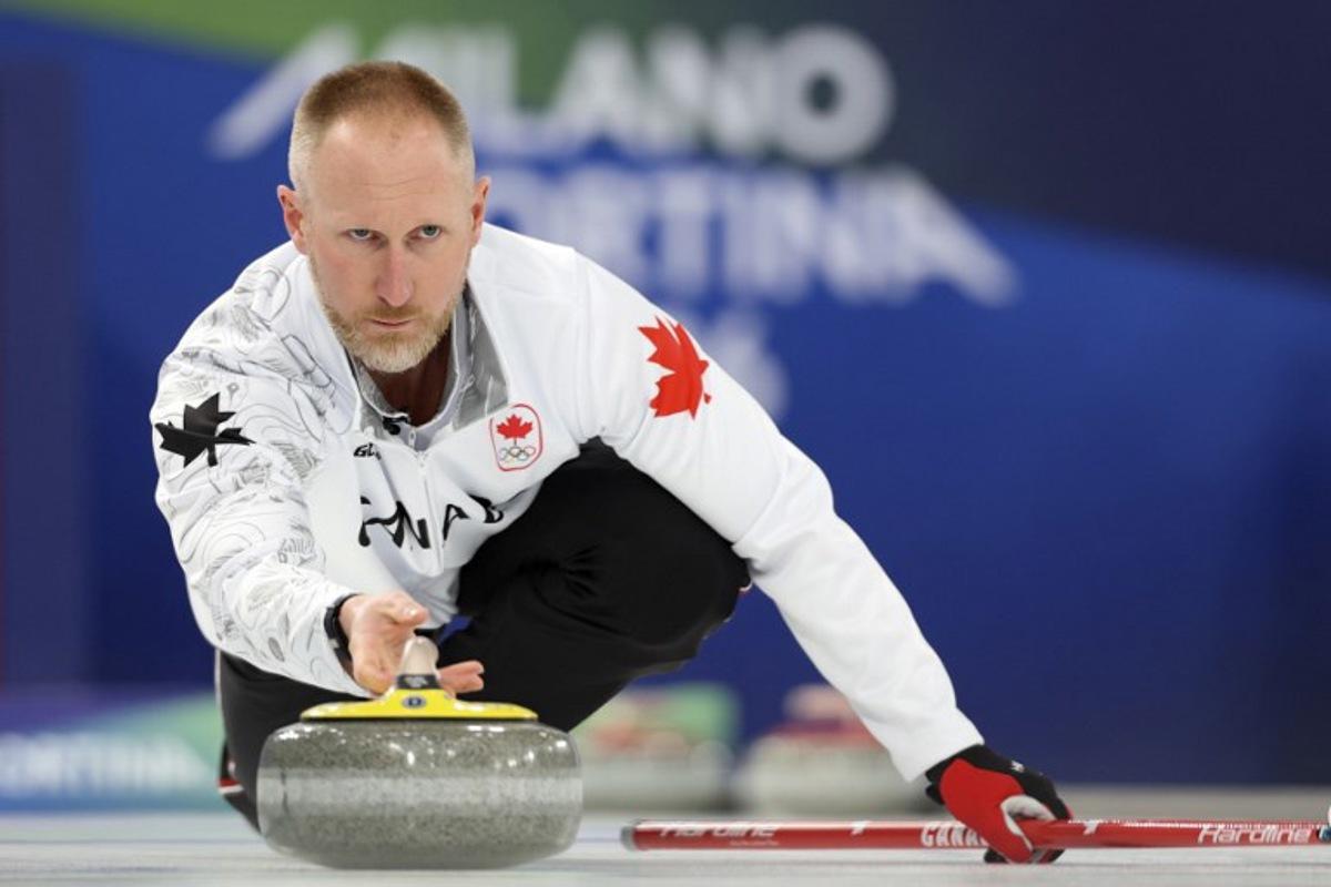 Canada's Brad Jacobs delivers the stone in the curling men's round robin between Norway and Canada during the Milano Cortina 2026 Winter Olympic Games at the Cortina Curling Olympic Stadium in Cortina d'Ampezzo on February 19, 2026.  Odd ANDERSEN / AFP