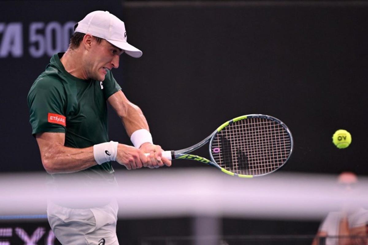 Raphael Collignon of Belgium hits a return during his men's singles match against Brandon Nakashima of the US at the Brisbane International tennis tournament in Brisbane on January 9, 2026.  William WEST / AFP