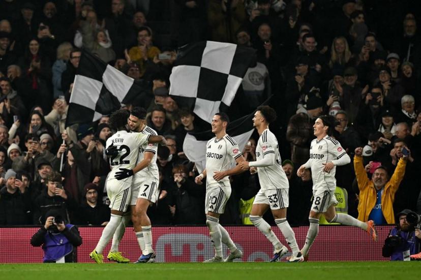 Fulham's Mexican striker #07 Raul Jimenez (2L) celebrates scoring the opening goal during the English Premier League football match between Fulham and Nottingham Forest at Craven Cottage in London on December 22, 2025.  Ben STANSALL / AFP