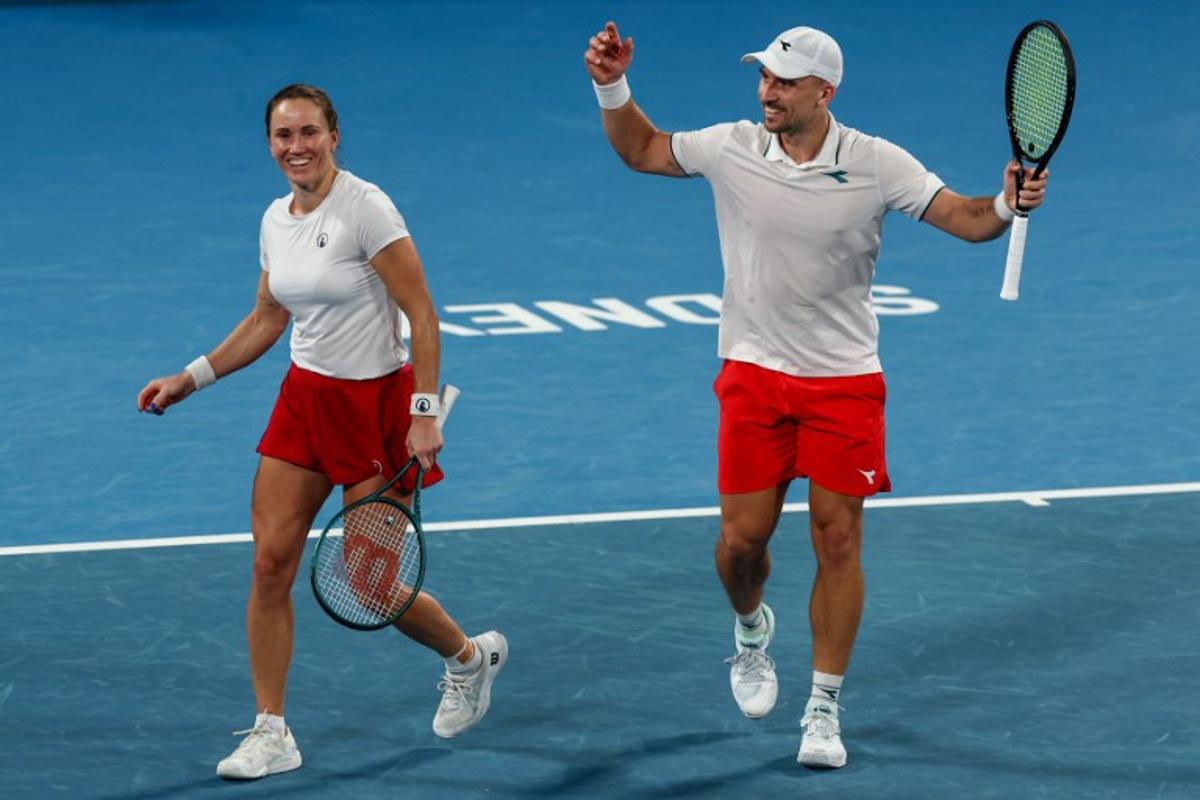 Poland's Jan Zielinski (R) and Katarzyna Kawa celebrate after winning the first set against USA's Coco Gauff and Christian Harrison during their mixed doubles semi-final match at the United Cup tennis tournament in Sydney on January 10, 2026.   Izhar KHAN / AFP