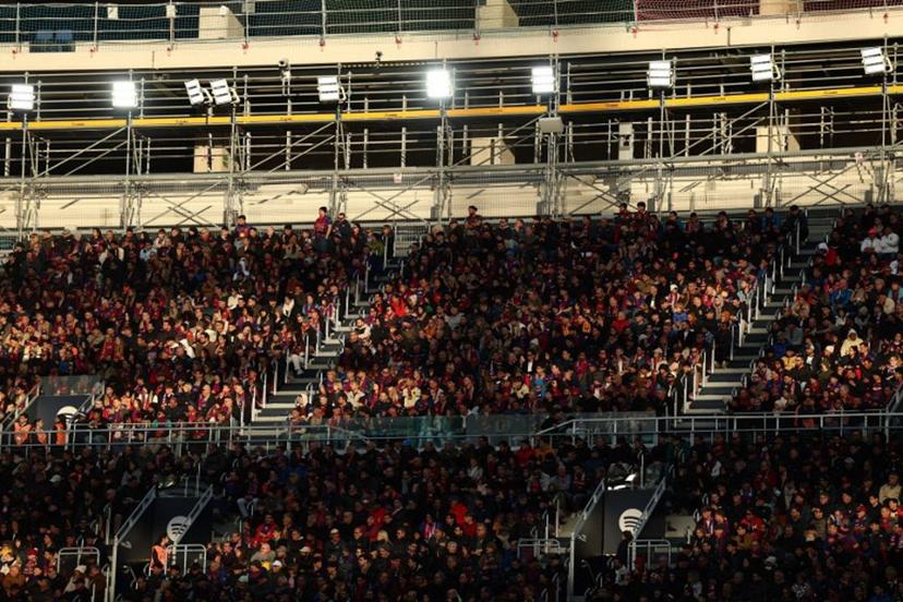 Fans watch the game from the stands during the Spanish league football match between FC Barcelona and Athletic Club Bilbao at Camp Nou Stadium in Barcelona on November 22, 2025.  Josep LAGO / AFP