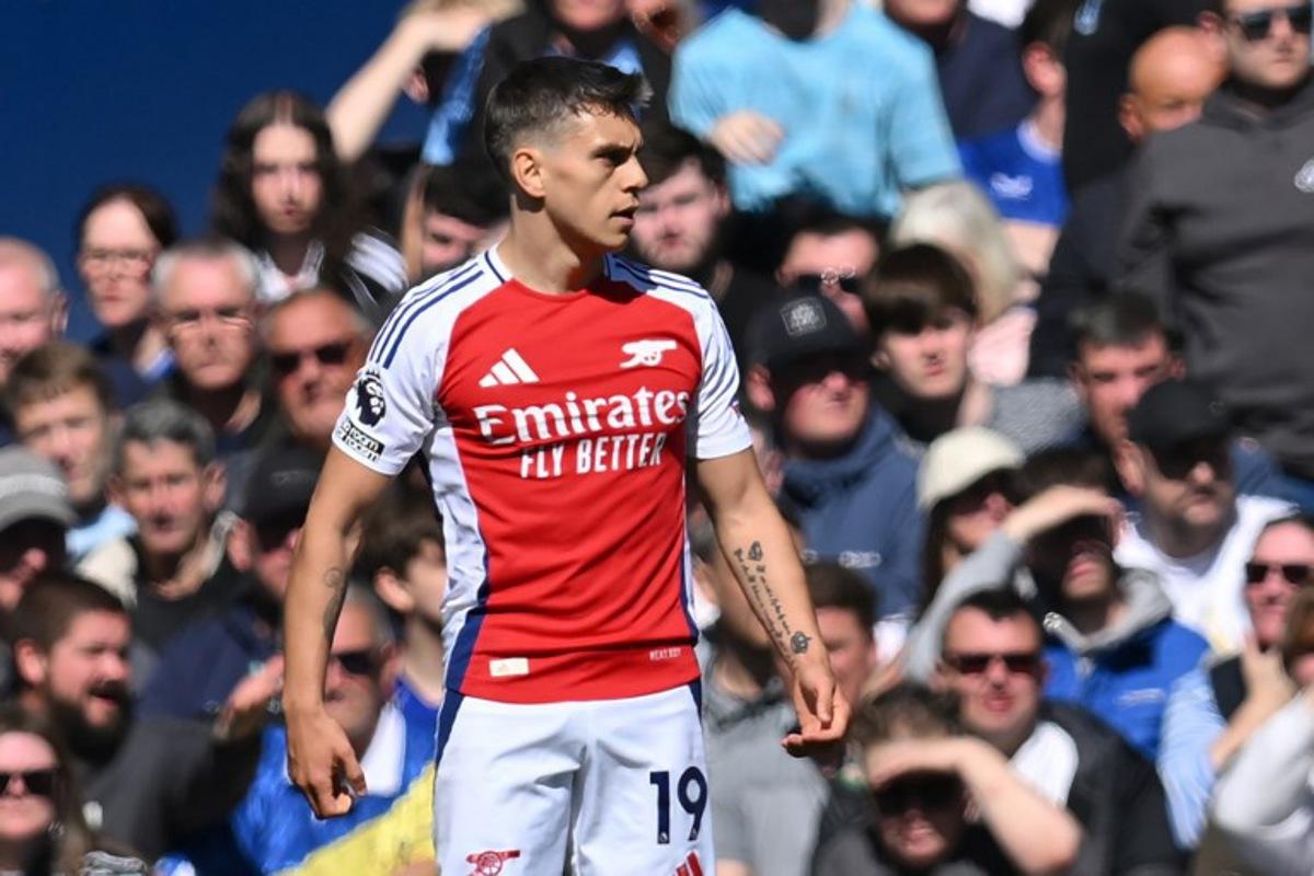 Arsenal's Belgian midfielder #19 Leandro Trossard reacts after scoring the opening goal of the English Premier League football match between Everton and Arsenal at Goodison Park in Liverpool, north west England on April 5, 2025.  ANDY BUCHANAN / AFP