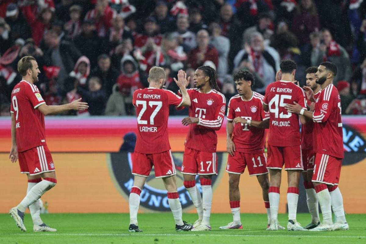 Bayern Munich's French midfielder #17 Michael Olise (3rd L) celebrates scoring the 3-0 goal with his teammates during the German first division Bundesliga football match between FC Bayern Munich and RB Leipzig in Munich, southern Germany, on October 17, 2026.  Alexandra BEIER / AFP