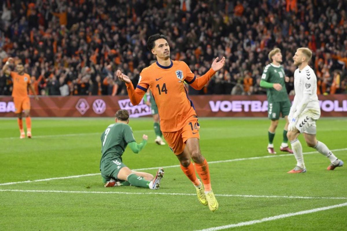 Netherlands' midfielder #14 Tijjani Reijnders (C) celebrates after scoring the Netherlands first goal during the FIFA World Cup 2026 Group G European qualification football match between the Netherlands and Lithuania at the Johan Cruijff Arena, in Amsterdam, on November 17, 2025.  JOHN THYS / AFP