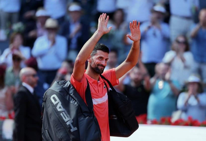 Serbia's Novak Djokovic waves after losing against Italy's Matteo Arnaldi  at the end of their 2025 ATP Tour Madrid Open tennis tournament second round singles match at the Caja Magica in Madrid, on April 26, 2025.  Thomas COEX / AFP