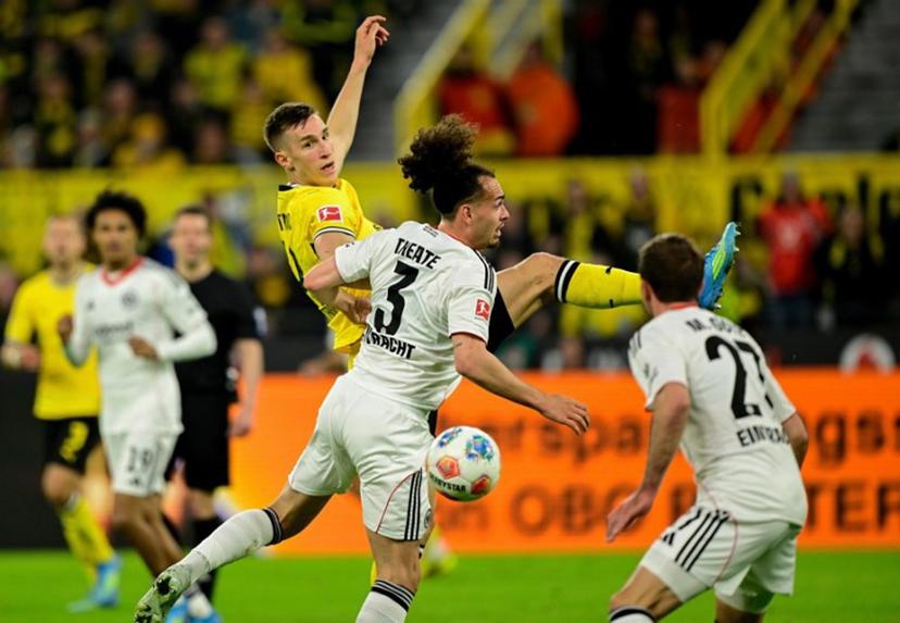 Dortmund's German defender #04 Nico Schlotterbeck and Frankfurt's Belgian defender #03 Arthur Theate vie for the ball during the German first division Bundesliga football match between BVB Borussia Dortmund and Eintracht Frankfurt in Dortmund, western Germany on May 8, 2026.  INA FASSBENDER / AFP