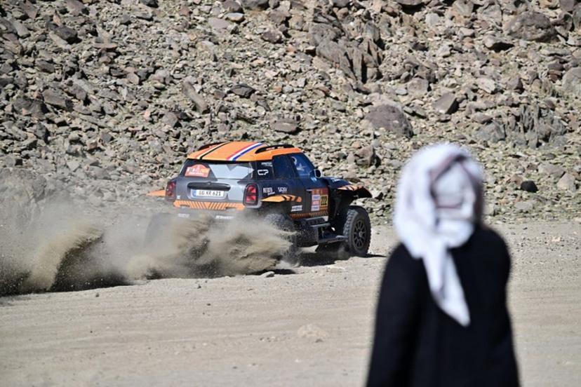 A local watches X-Raid Team Belgian driver Guillaume de Mevius and French co-driver Mathieu Baumel compete in the prologue, which determines the starting line-up for the first stage of the 48th edition of the Dakar Rally 2026, between Yanbu and Yanbu, Saudi Arabia, on January 3, 2026.  Giuseppe CACACE / AFP