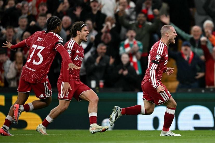 Liverpool's Argentinian midfielder #10 Alexis Mac Allister (R) celebrates scoring the team's second goal during the UEFA Champions League football match between Liverpool and Atletico Madrid at Anfield in Liverpool, north west England on September 9, 2026.  Paul ELLIS / AFP