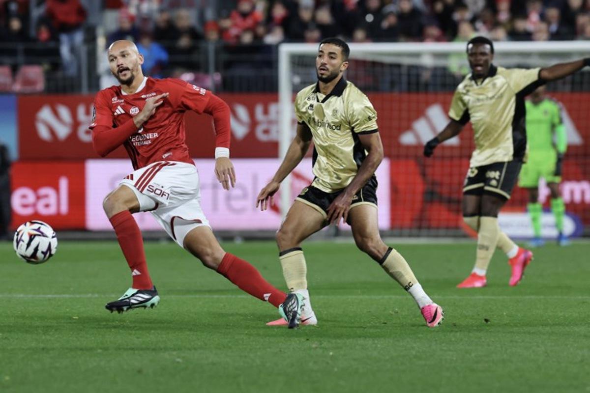Brest's French forward #19 Ludovic Ajorque (L) fights for the ball with Nice's Egyptian defender #05 Mohamed Abdelmonem during the French L1 football match between Stade Brestois 29 and OGC Nice at the Francis-Le Ble Stadium in Brest, western France on October 23, 2026.  Fred TANNEAU / AFP