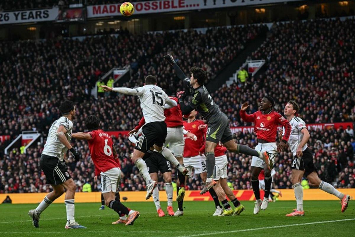 Manchester United's Belgian goalkeeper #31 Senne Lammens (centre R) punches the ball clear from a corner kick during the English Premier League football match between Manchester United and Fulham at Old Trafford in Manchester, north west England, on February 1, 2026.  Paul ELLIS / AFP