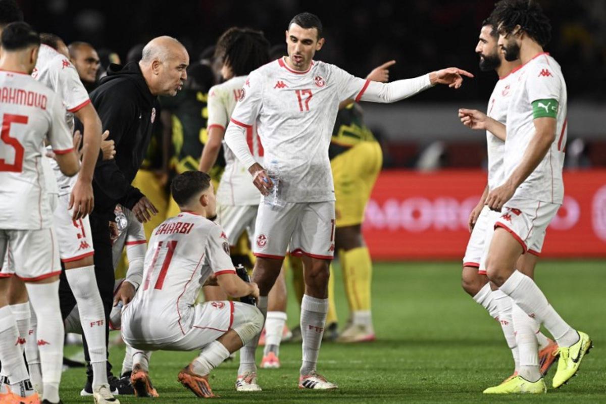 Tunisia's head coach Samy Trabelsi (3 L) speaks to his players during the Africa Cup of Nations (CAN) round of 16 football match between Mali and Tunisia at Mohammed V Stadium in Casablanca on January 3, 2026.  Paul ELLIS / AFP