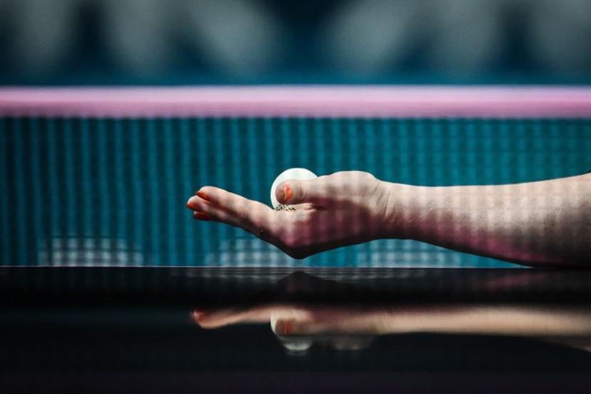 The reflection of the arm and hand of Netherlands' Britt Eerland is pictured on the table tennis table as she serves the ball to Czech Republic's Hana Matelova during their women's table tennis singles round of 32 at the Paris 2024 Olympic Games at the South Paris Arena in Paris on July 29, 2024.  JUNG Yeon-je / AFP