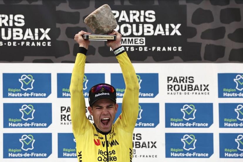Winner Team Visma - Lease a Bike's Belgian rider Wout van Aert celebrates on the podium of the 123rd edition of the Paris-Roubaix one-day classic cycling race, 258.3 km between Compiègne and Roubaix, at the Vélodrome André-Pétrieux in Roubaix, northern France, on April 12, 2026.  Anne-Christine POUJOULAT / AFP