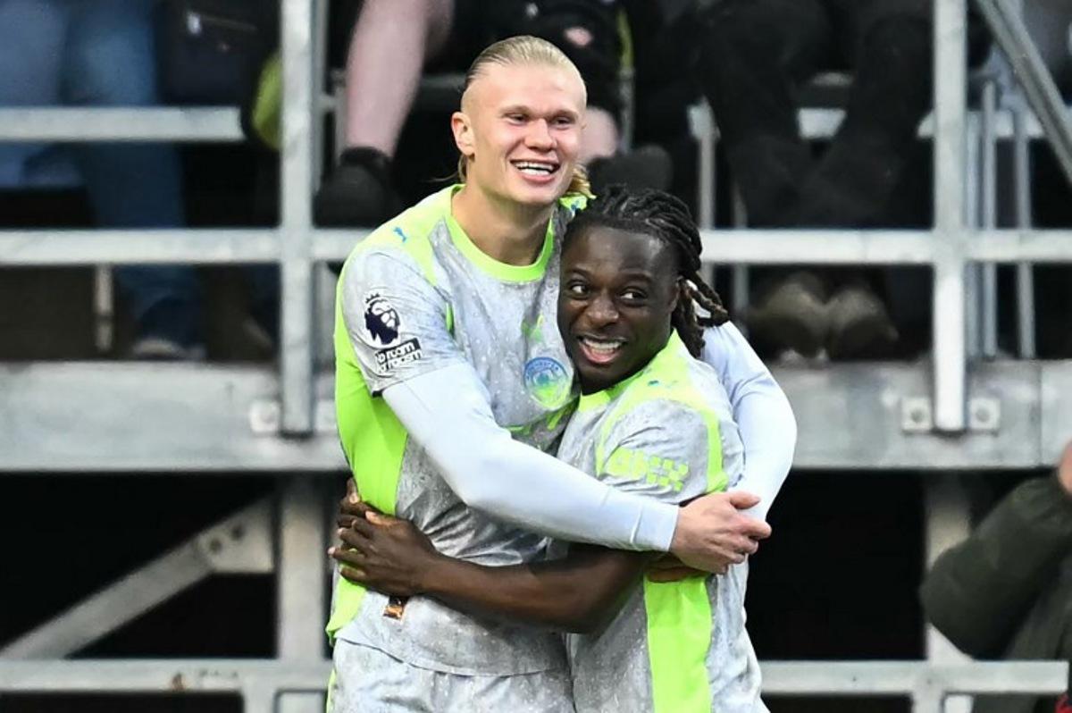 Manchester City's Norwegian striker #09 Erling Haaland (L) celebrates scoring the team's first goal during the English Premier League football match between Burnley and Manchester City at Turf Moor in Burnley, north-west England on April 22, 2026.  Paul ELLIS / AFP