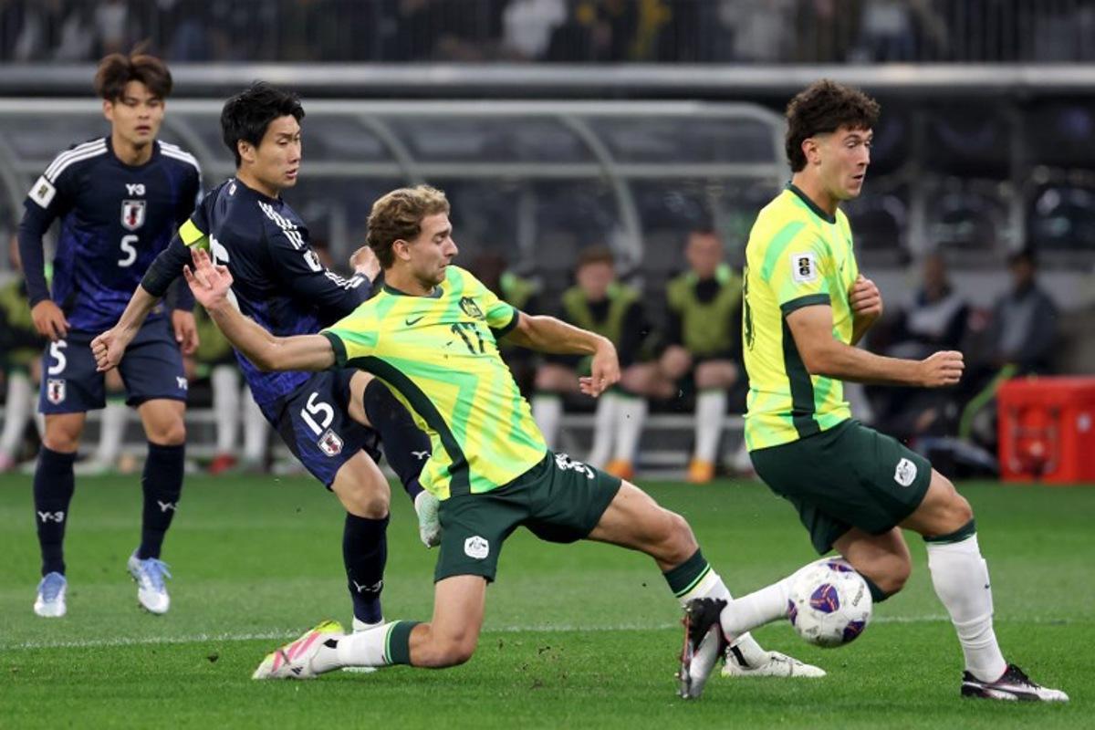 Australia's Ryan Teague (C) attempts to gain possession of the ball during the 2026 FIFA World Cup Asian Qualifier match between Australia and Japan at Optus Stadium in Perth on June 5, 2025.  COLIN MURTY / AFP
