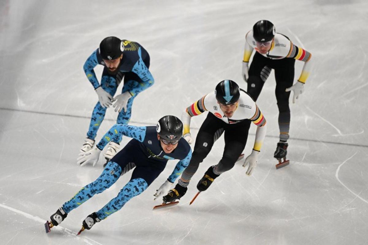 Kazakhstan's Nurtilek Kazhgali (L) and Belgium's Stijn Desmet compete in the final B of the men's 5000m relay at the ISU World Cup Short Track Speed Skating event in Beijing on December 10, 2023.  Jade Gao / AFP