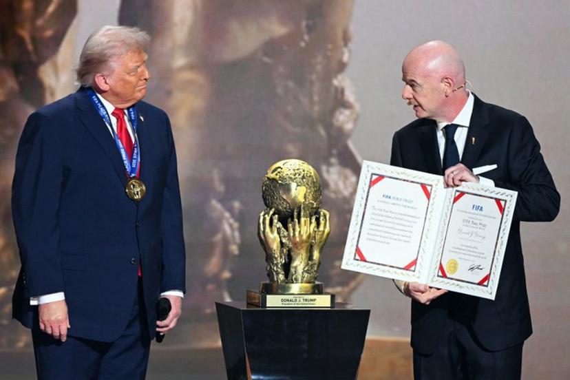 (L-R) US President Donald Trump receives the FIFA Peace Prize from Italian Fifa President Gianni Infantino during the draw for the 2026 FIFA Football World Cup taking place in the US, Canada and Mexico, at the Kennedy Center, in Washington, DC, on December 5, 2025.  Jim WATSON / AFP