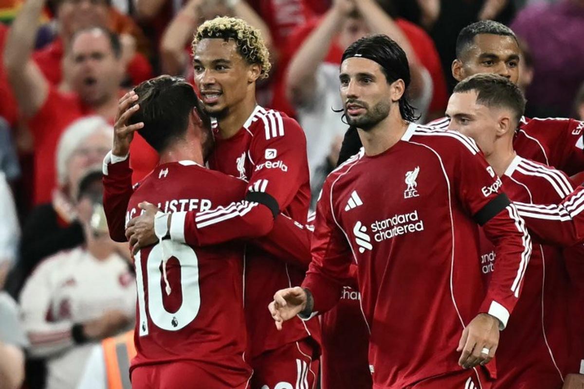 Liverpool's French striker #22 Hugo Ekitike (2L) celebrates with teammates after scoring the opening goal of the English Premier League football match between Liverpool and Bournemouth at Anfield in Liverpool, north west England on August 15, 2025.  Paul ELLIS / AFP