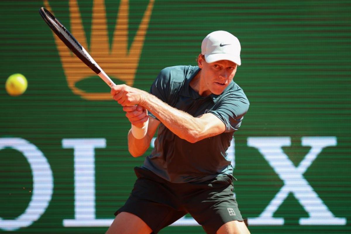 Italy's Jannik Sinner plays a backhand return to Czech Republic's Tomas Machac during their Monte Carlo ATP Masters Series Tournament round of 16 tennis match on Court Rainier III at the Monte-Carlo Country Club in Roquebrune-Cap-Martin, south-eastern France on April 9, 2026.  Valery HACHE / AFP