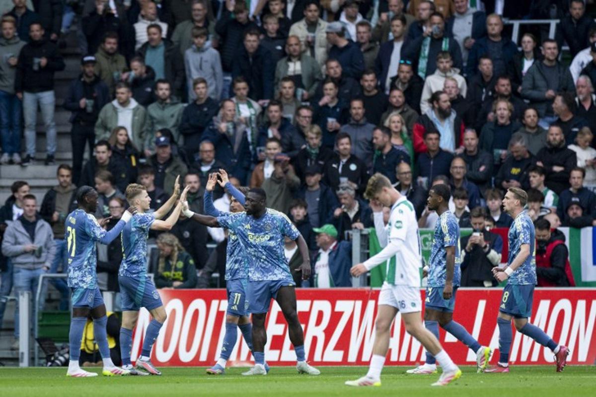 Ajax's Dutch forward #09 Brian Brobbey (C) celebrates with teammates after scoring the opening goal during the Dutch Eredivisie football match between FC Groningen and Ajax Amsterdam at Euroborg Stadium in Groningen on May 14, 2025.  Robin van Lonkhuijsen / ANP / AFP