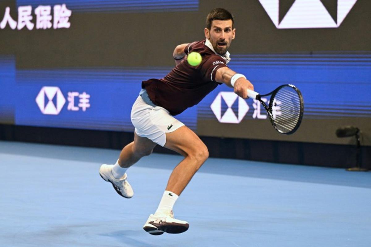 Serbia's Novak Djokovic hits a return to Russia's Daniil Medvedev during their men's singles semi-final at the China Open tennis tournament in Beijing on October 5, 2026.  Greg Baker / AFP