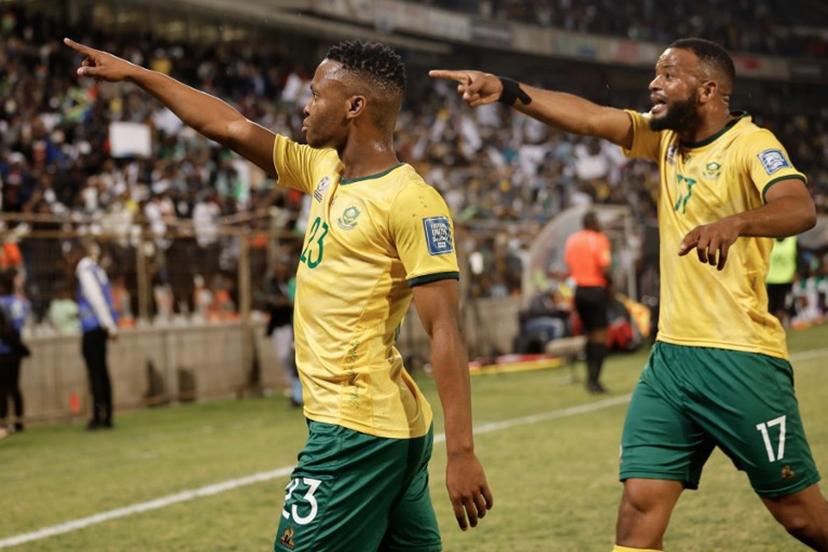 South Africa's midfielder #23 Mohau Nkota (L) celebrates after kicking a ball that lead to Nigeria's own goal during the FIFA World Cup 2026 Africa qualifiers group C match between South Africa and Nigeria at the Free State Stadium in Bloemfontein on September 9, 2025.  Phill Magakoe / AFP