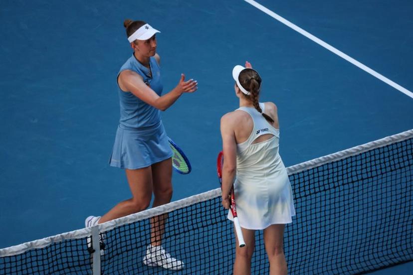 Kazakhstan's Elena Rybakina (R) and Belgium's Elise Mertens shake hands at the net after their women's singles match on day nine of the Australian Open tennis tournament in Melbourne on January 26, 2026.  DAVID GRAY / AFP