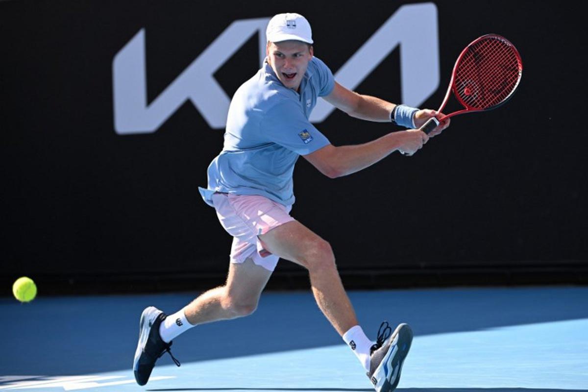 USA's Jenson Brooksby hits a return against USA's Tommy Paul during their men's singles match on day six of the Australian Open tennis tournament in Melbourne on January 21, 2023.  WILLIAM WEST / AFP