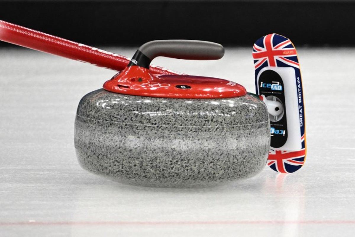 A detail shot of a curling stone and a curling broom during the women's gold medal game of the Beijing 2022 Winter Olympic Games curling competition between Japan and Great Britain at the National Aquatics Centre in Beijing on February 20, 2022.  Jeff PACHOUD / AFP