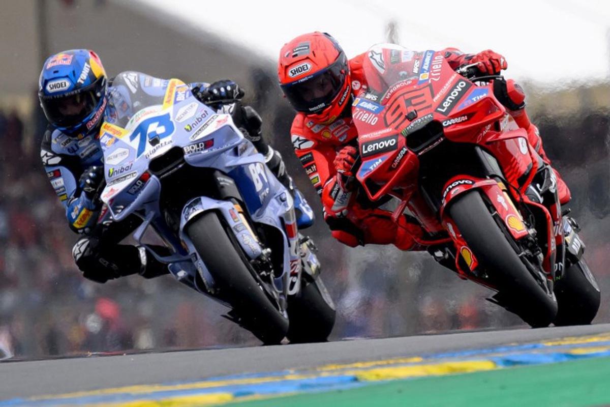 Ducati Lenovo Team's Spanish MotoGP rider Marc Marquez (R) rides ahead of his brother BK8 Gresini Racing MotoGP team's Spanish MotoGP rider Alex Marquez during the France Moto GP race at the Le Mans Circuit on May 11, 2025.    Loic VENANCE / AFP