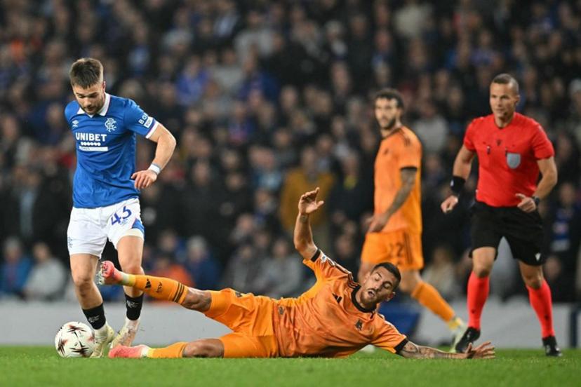 Roma's Italian midfielder #07 Lorenzo Pellegrini (R) goes down in a challenge with Rangers' Belgian midfielder #43 Nicolas Raskin (L) during the UEFA Europa League league-stage football match between Rangers and Roma at Ibrox Stadium in Glasgow on November 6, 2025.  ANDY BUCHANAN / AFP