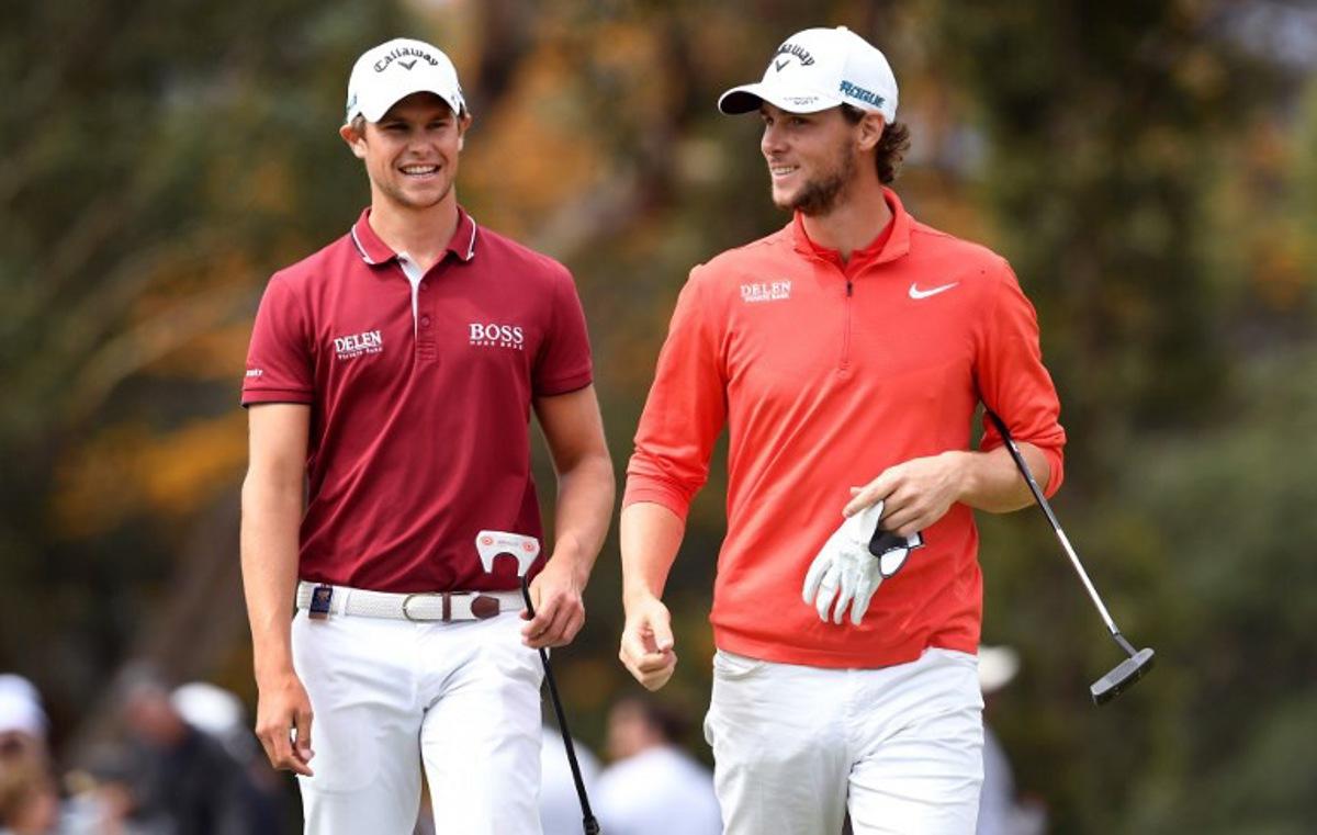 Thomas Detry (L) and Thomas Pieters (R) of Belgium celebrate on the way to winning the World Cup of Golf at the Metropolitan Golf Club in Melbourne on November 25, 2018.  William WEST / AFP