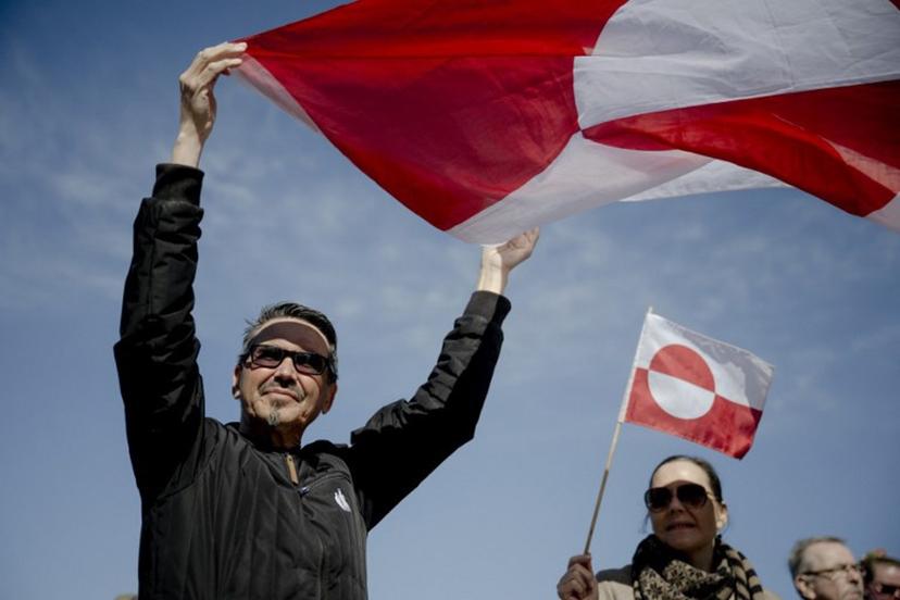 Protestors hold the Greenlandic flag as the demonstrate against the new American consulate in Nuuk, Greenland, on May 21, 2026.   Oscar Scott Carl / Ritzau Scanpix / AFP