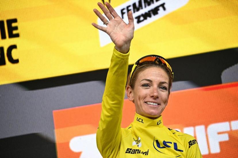 Team Visma | Lease a Bike's French rider Pauline Ferrand-Prevot celebrates with the overall leader's yellow jersey on the podium for the fourth edition of the Women's Tour de France cycling race at the end of the 9th and final stage (out of 9), 124.1 km from Praz-sur-Arly to Chatel, in Chatel eastern France, on August 3, 2025.  JULIEN DE ROSA / AFP