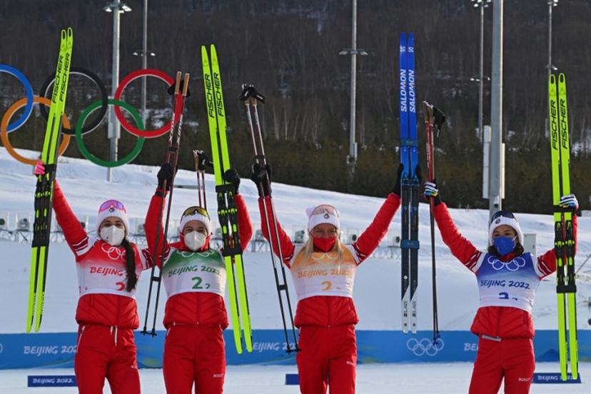 (From L) Russia's Yulia Stupak, Russia's Natalia Nepryaeva, Russia's Tatiana Sorina and Russia's Veronika Stepanova celebrate on the podium after Russia won Gold in the women's Cross Country 4x5km relay event during the Beijing 2022 Winter Olympic Games on February 12, 2022, at the Zhangjiakou National Cross-Country Skiing Centre.  Pierre-Philippe MARCOU / AFP